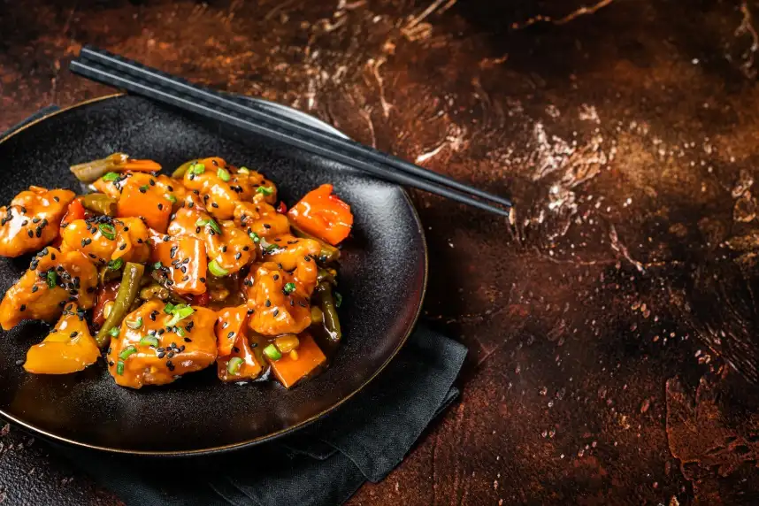 Crispy halal Orange Chicken in Plano featuring tender chicken coated in a sweet and tangy authentic Chinese sauce